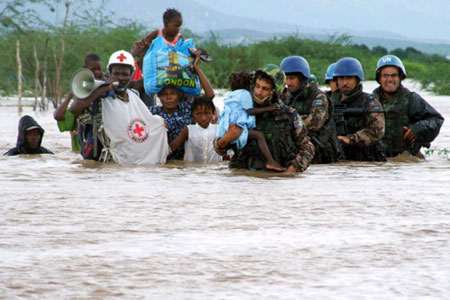 Members of the Jordanian battalion of the United Nations Stabilization Mission in Haiti (MINUSTAH) rescue children after their orphanage was destroyed in a hurricane.