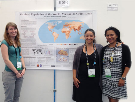 CIESIN geospatial information specialists Erin Doxsey-Whitfield, Dara Mendeloff, and Linda Pistolesi standing in front of the poster they created describing development highlights of the fourth version of the Gridded Population of the World (GPW) data set.