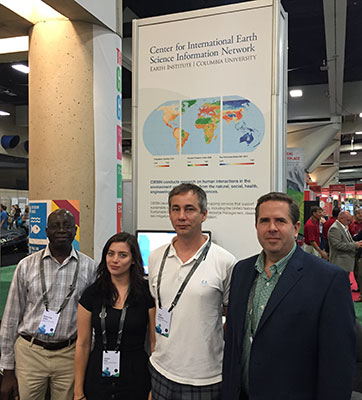 CIESIN staff standing in front of exhibit booth at 2016 Esri User Cionference